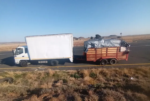 A Lewin Projects truck and trailer travelling on the open road during a long-distance transport job